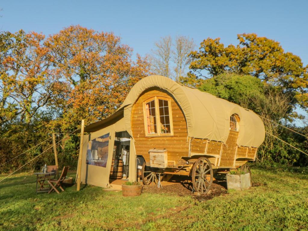 a tiny house on display in a field at The Wagon at Burrow Hill in Ottery Saint Mary