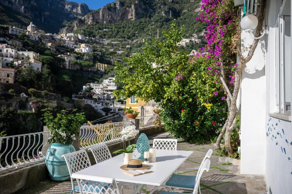 a table and chairs on a balcony with a view at Villa Dalu in Positano