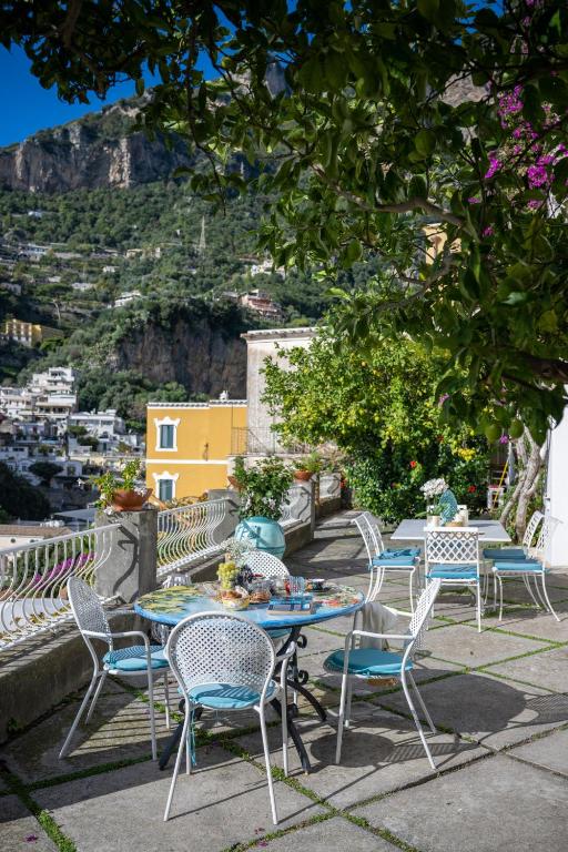 a table and chairs with a view of a city at Villa Dalu in Positano
