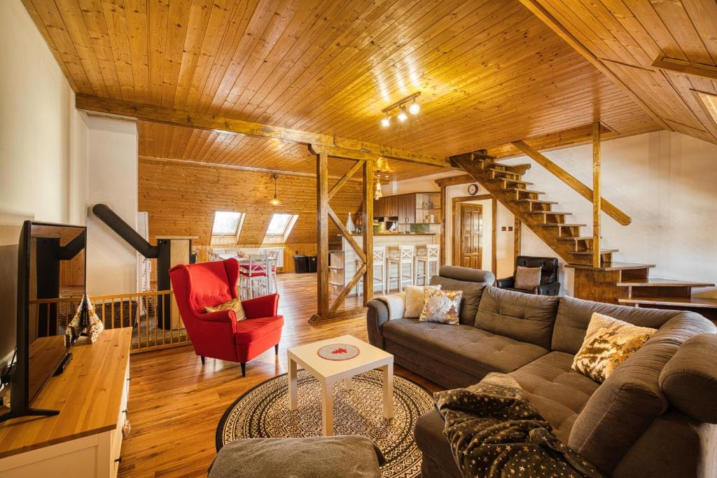 a living room with a couch and a table at Apartmány Pod Šerákem in Lipova Lazne