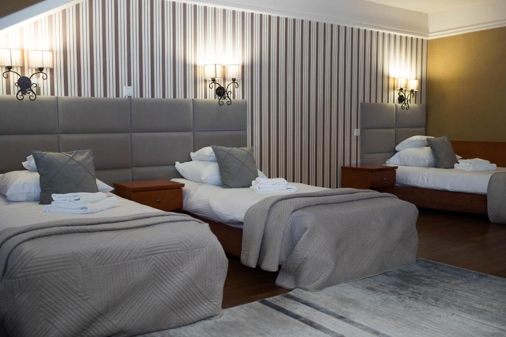 Posteľ alebo postele v izbe v ubytovaní Hotel Wenecki