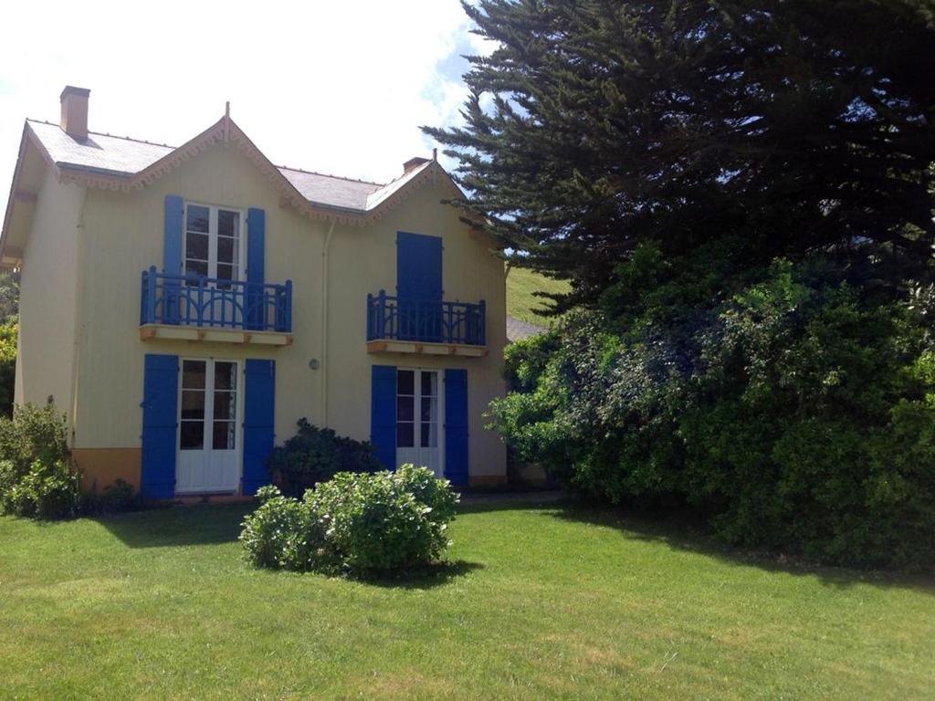 ein Haus mit blauen Fensterläden und einem Hof in der Unterkunft Maison Le Palais, 4 pièces, 6 personnes - FR-1-418-20 in Le Palais