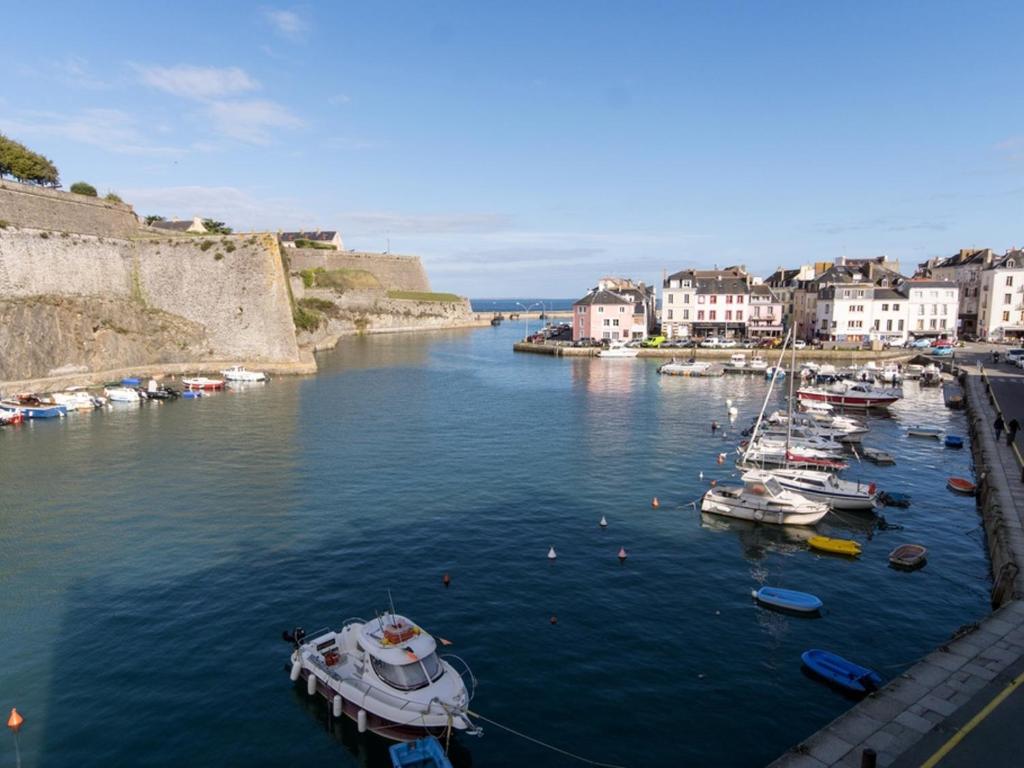 a group of boats docked in a river with buildings at Appartement Le Palais, 3 pièces, 4 personnes - FR-1-418-80 in Le Palais