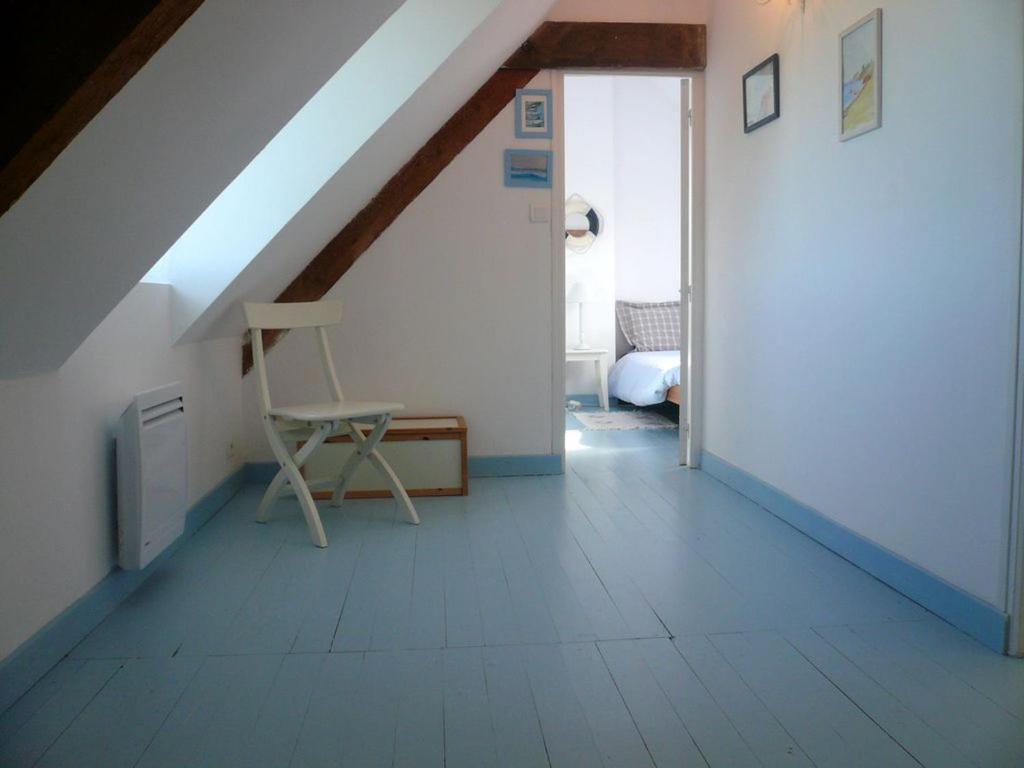 a attic room with a chair and a window at Maison Le Palais, 5 pièces, 5 personnes - FR-1-418-76 in Le Palais