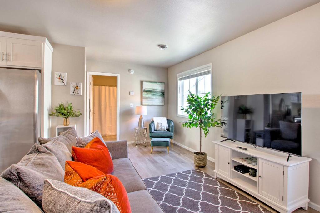 a living room with a couch and a flat screen tv at Modern Fargo Townhome in Central Location! in Fargo