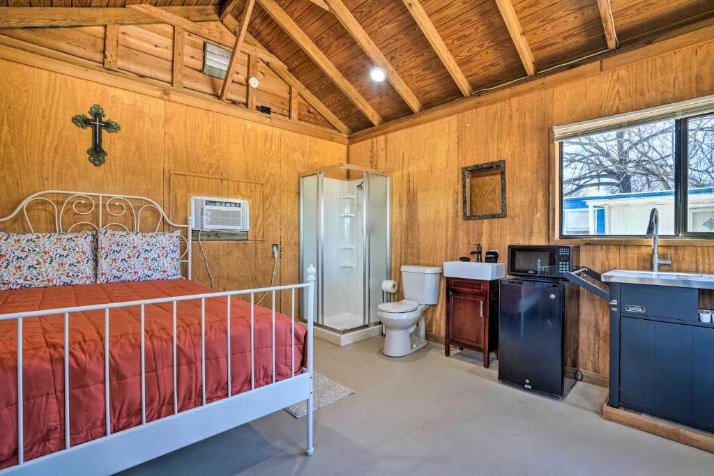 a bedroom with a bed and a sink and a toilet at Waterfront Studio with Fire Pit on Lake Dunlap! in New Braunfels