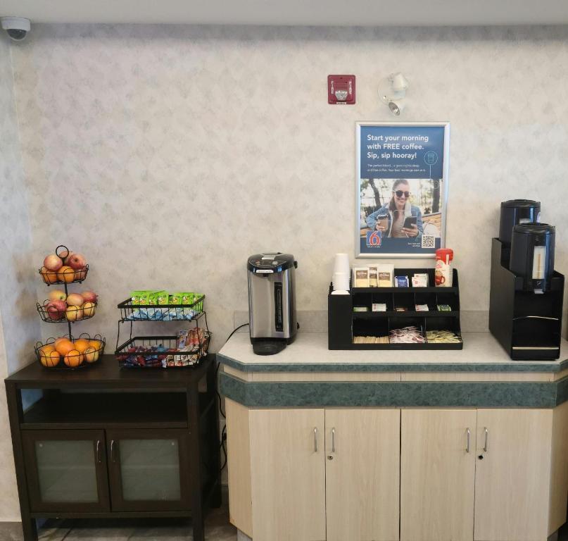 a counter in a office with a coffee maker and fruit at Motel 6-Grande Prairie, AB in Grande Prairie