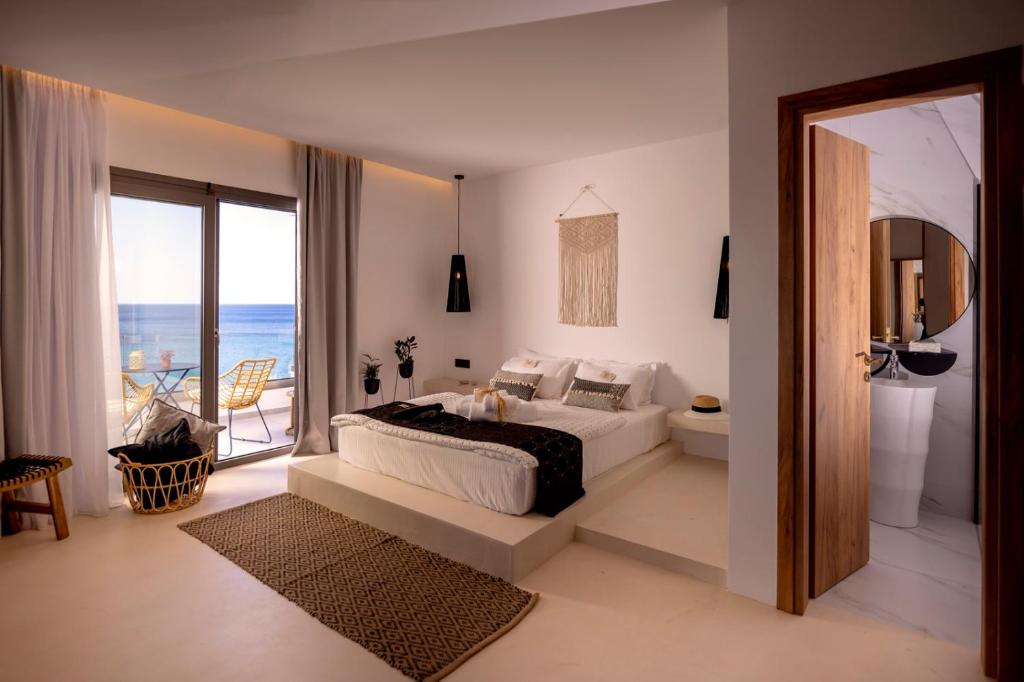 a bedroom with a bed and a view of the ocean at Sofi Mar - Plomari - The place to be in Plomarion