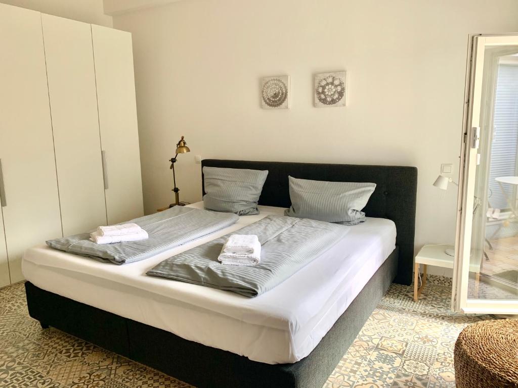 a bedroom with a large bed with two towels on it at Werderapartment, FeWo und DZ in Werder