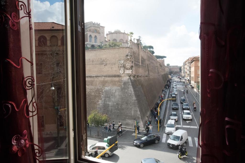 a view from a window of a city street with cars at Quo Vadis in Rome