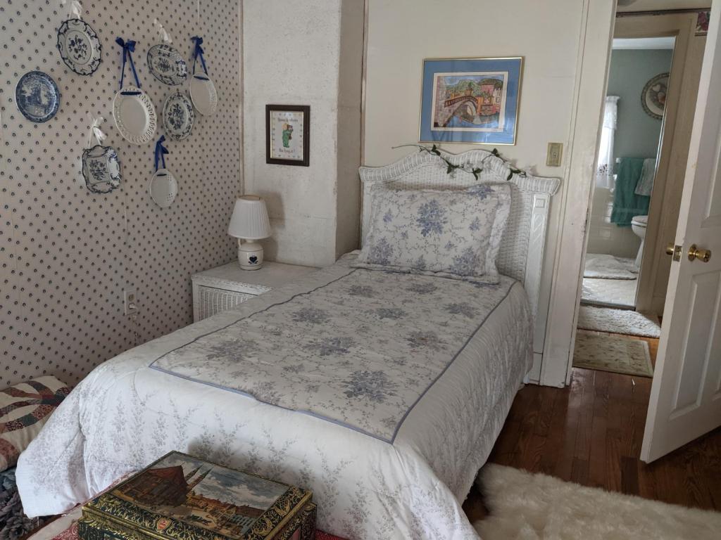a bedroom with a bed with a white bedspread at Baylies Home in Tully