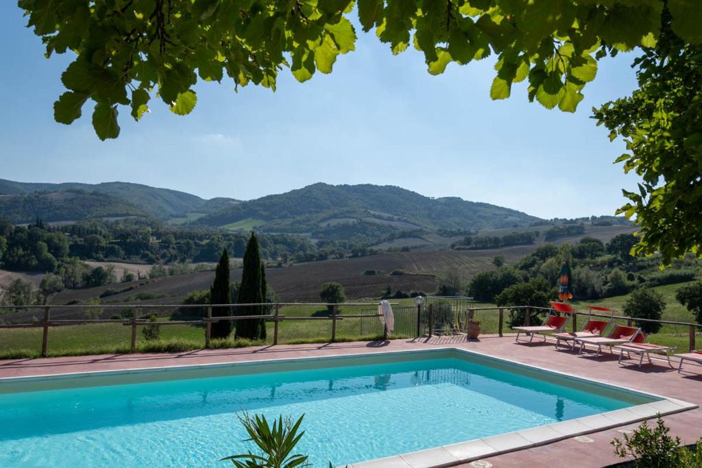 a swimming pool with a view of the mountains at Agriturismo Dai Mori in Isola del Piano