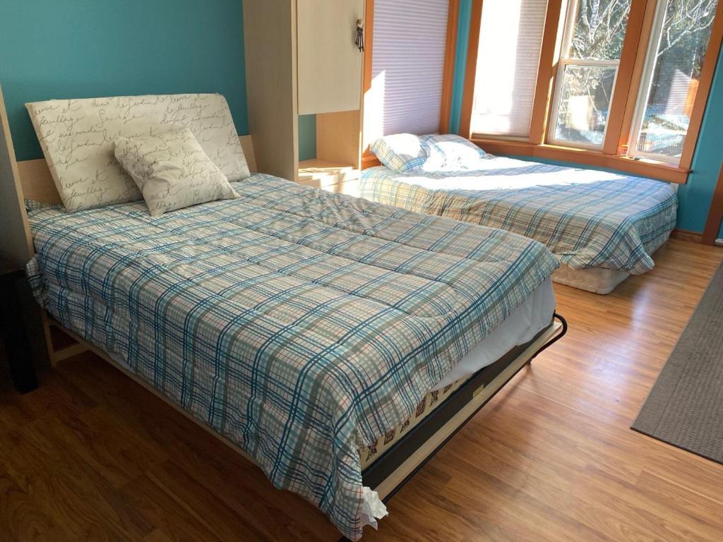 a bedroom with two beds and a window at Beaver Lake Resort Site #36 in Lake Cowichan