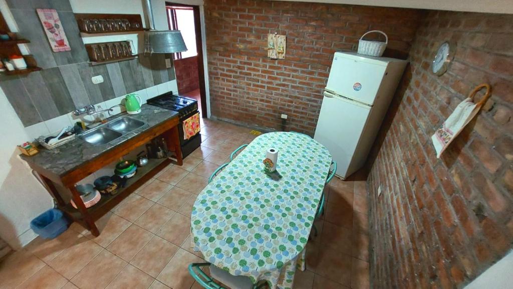 a kitchen with a chair and a sink and a refrigerator at Elst House in Mendoza