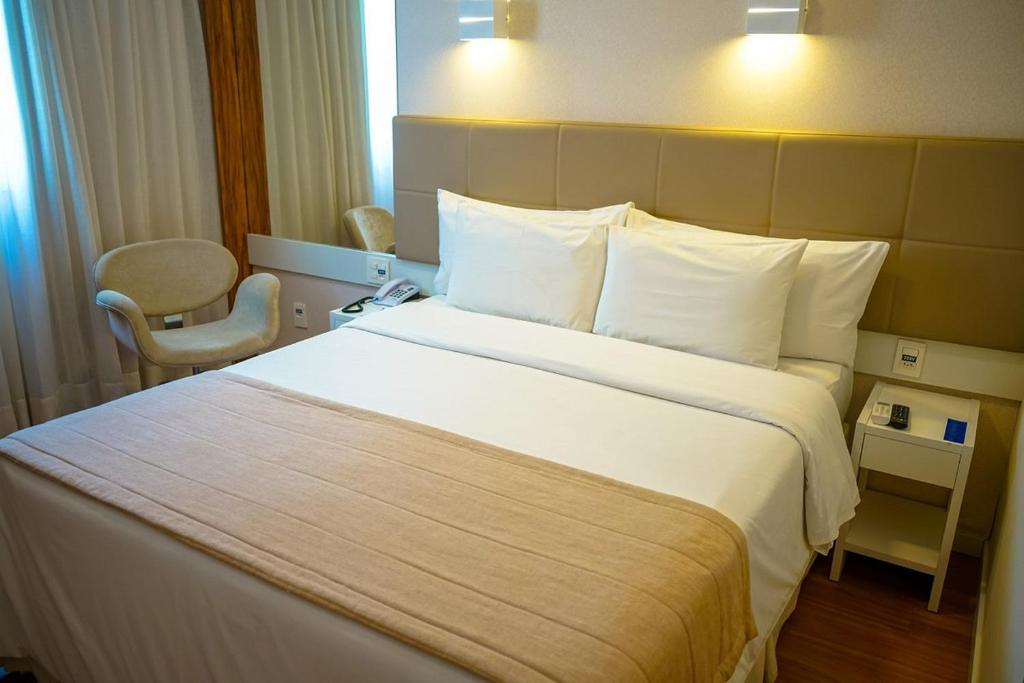 Postel nebo postele na pokoji v ubytování Linhares Design Hotel