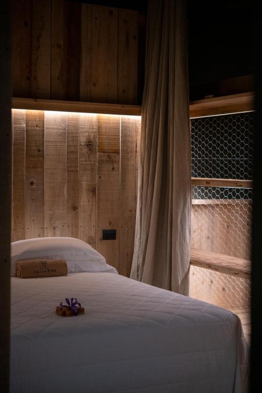 A bed or beds in a room at Duca Di Dolle Wine & Relais