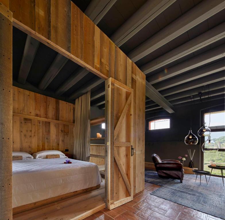 A bed or beds in a room at Duca Di Dolle Wine & Relais