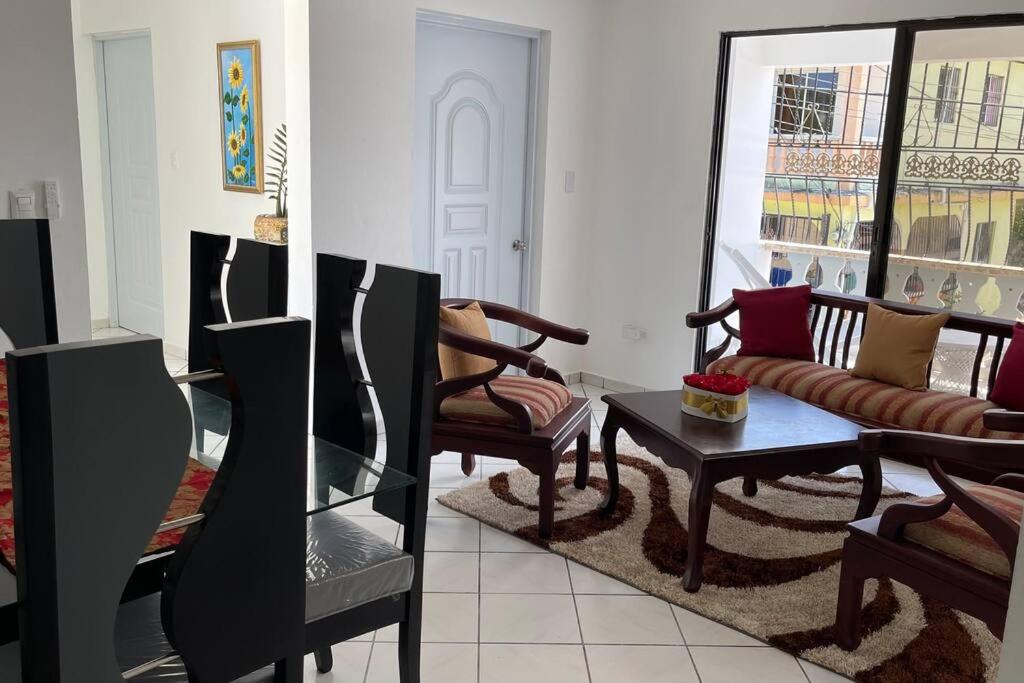 a living room with a couch and a table at Hermosa y acogedora casa Familiar como te mereces in San Felipe de Puerto Plata