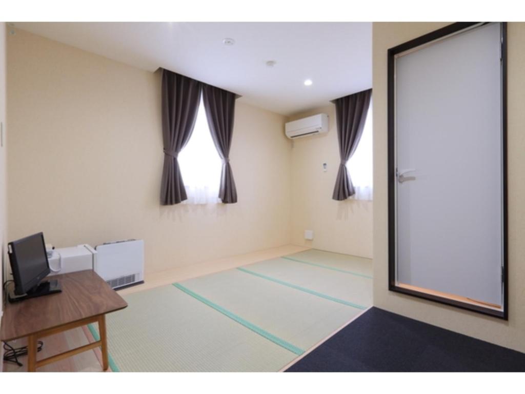 an empty room with a large window and a projection screen at Kusatsu Onsen 326 Yamanoyu Hotel - Vacation STAY 10465v in Kusatsu