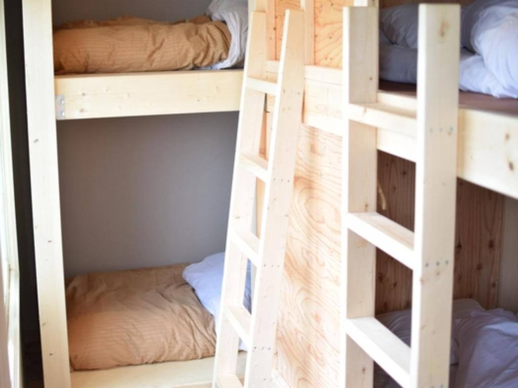 two sets of bunk beds in a dorm room at Noboribetsu Guest House AKA and AO - Vacation STAY 20484v in Noboribetsu