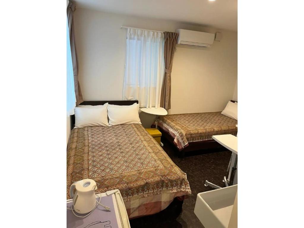a hotel room with two beds and a window at Tokyo stay Hut SARI - Vacation STAY 27239v in Tokyo