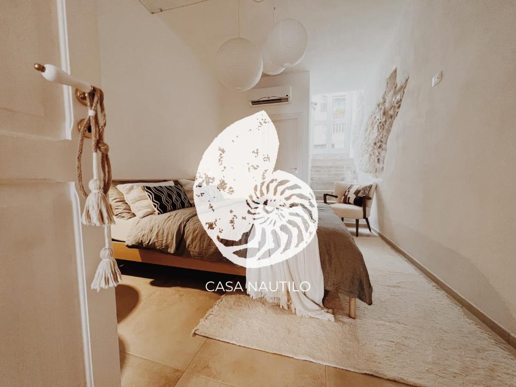 a bedroom with a bed with an umbrella on it at CASA NAUTILO - Porta Vecchia in Monopoli