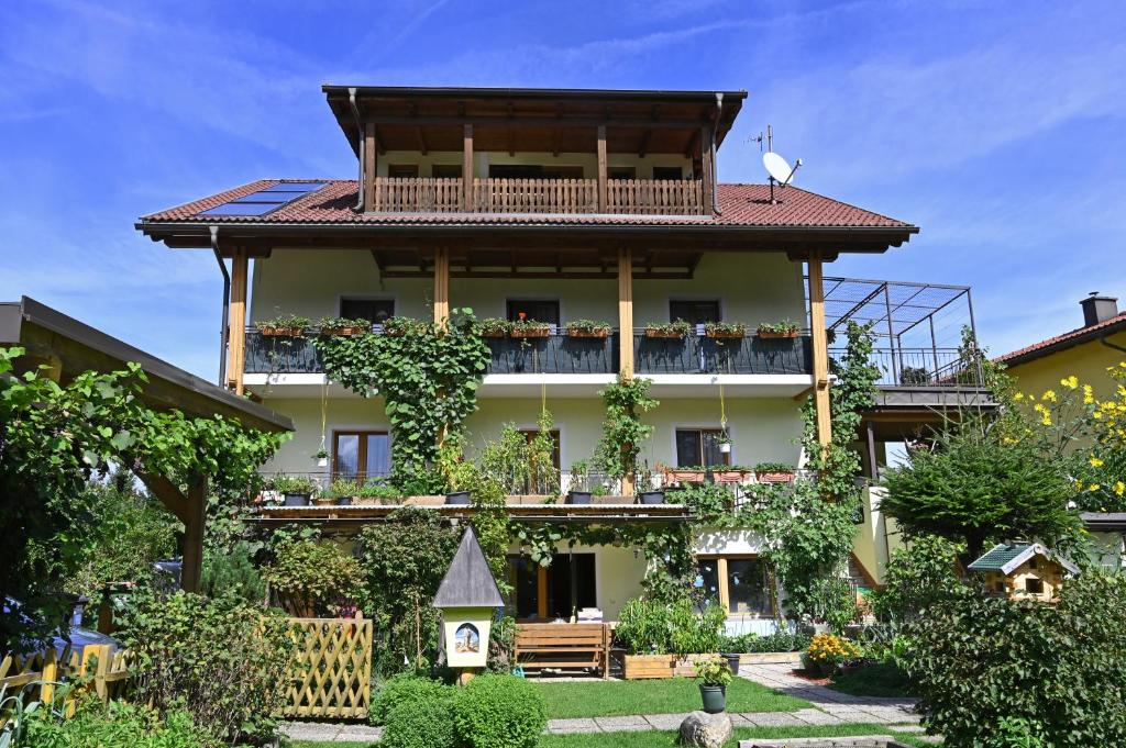 a large building with a balcony and a yard at Appartement Mittagskogel in Velden am Wörthersee