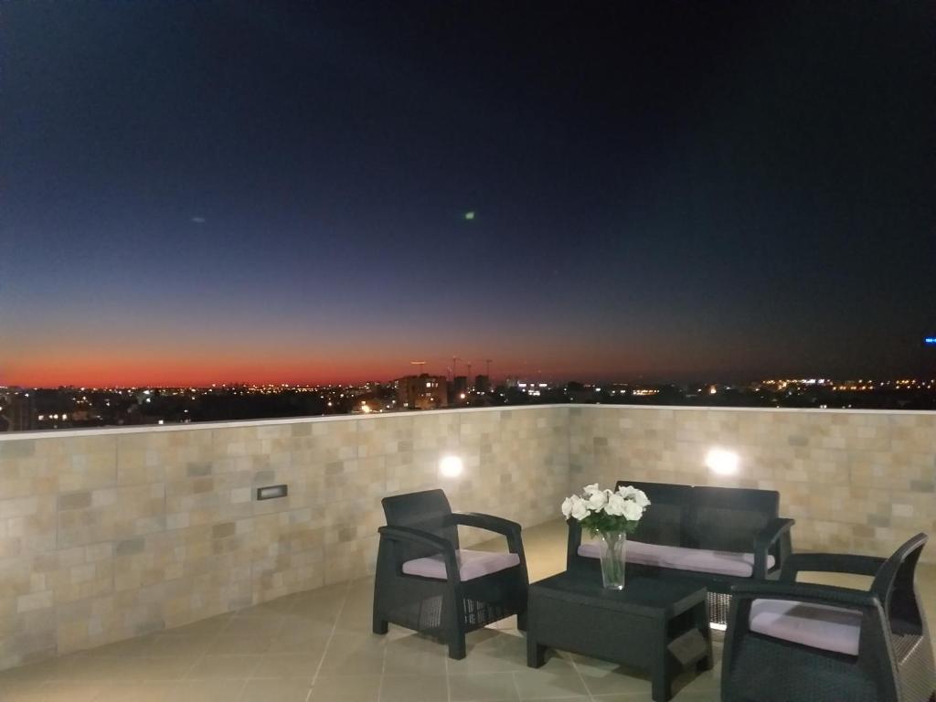 a balcony with chairs and a table with a view at Penthouse In The City in Rechovot