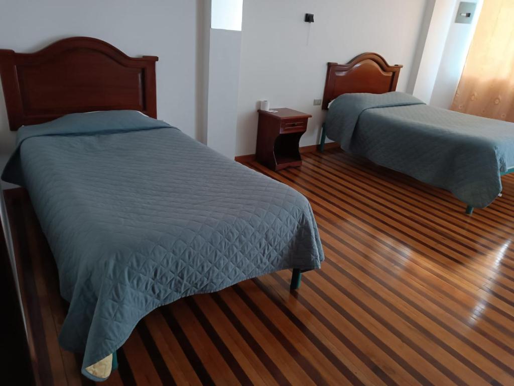 Postel nebo postele na pokoji v ubytování Hostal Pucará