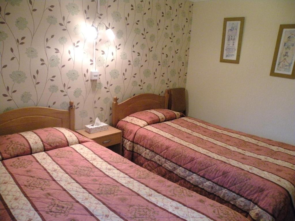 Letto o letti in una camera di Dorset Hotel, Isle of Wight