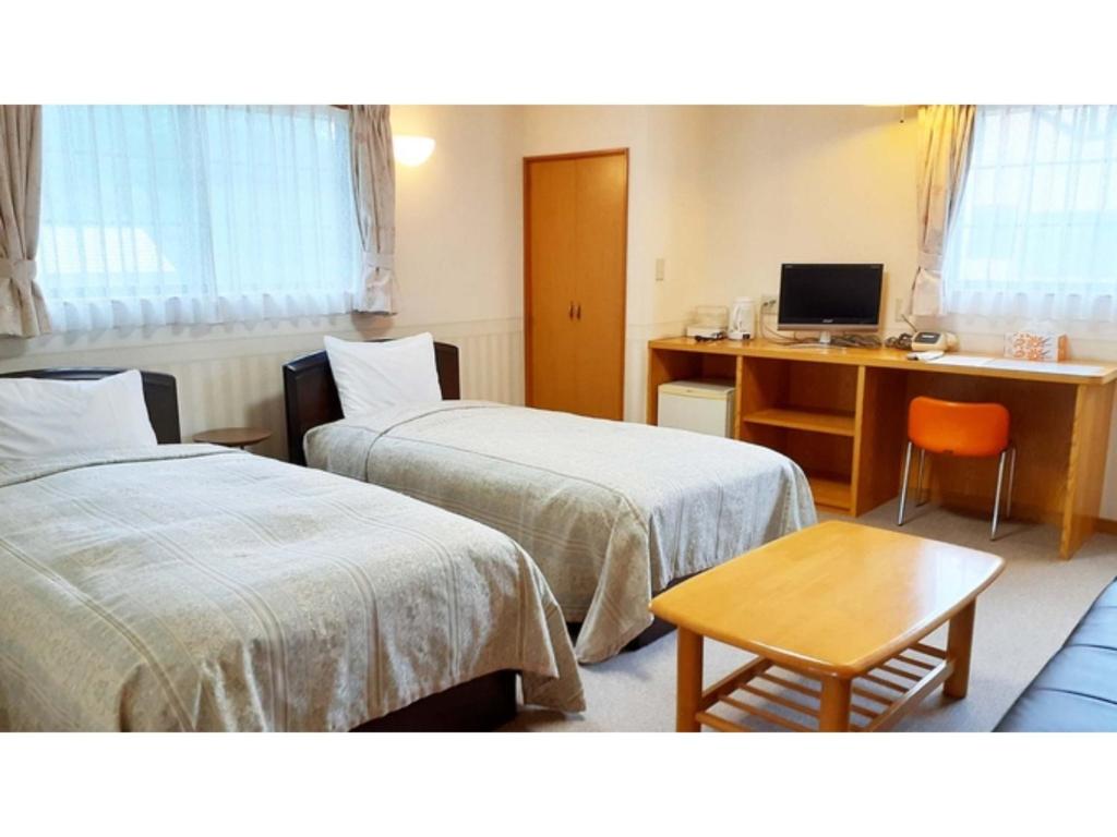 Кровать или кровати в номере Sudomari no Yado Sunmore - Vacation STAY 46736v