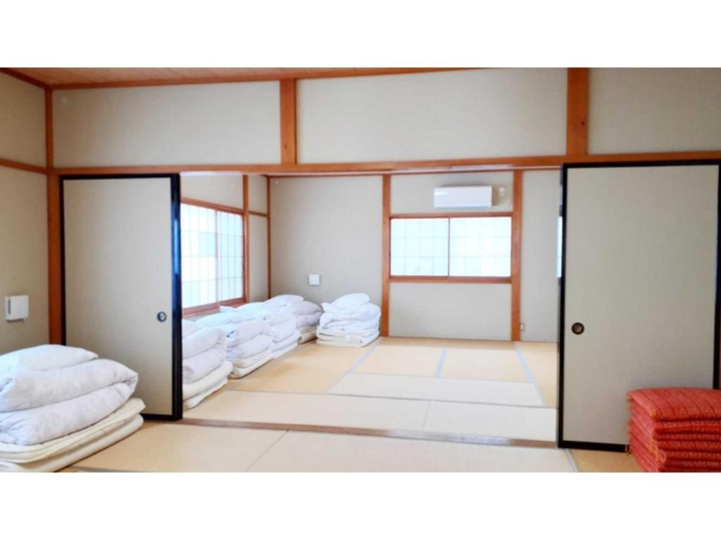 Un pat sau paturi într-o cameră la Sudomari no Yado Sunmore - Vacation STAY 46754v