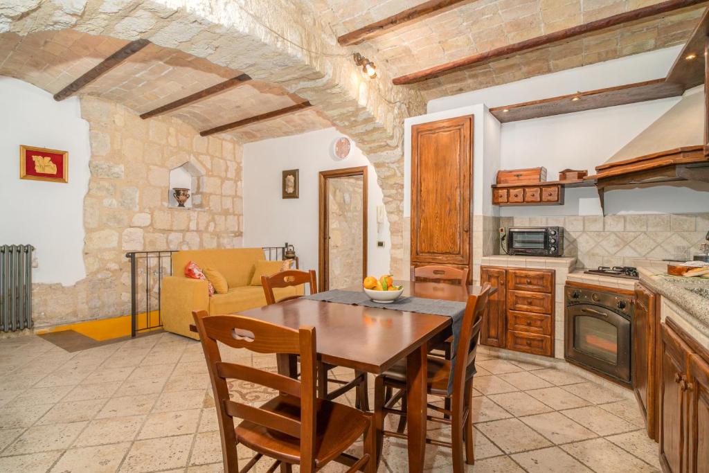 uma cozinha e sala de jantar com mesa e cadeiras em La Casa dell' Etrusco em Tarquinia