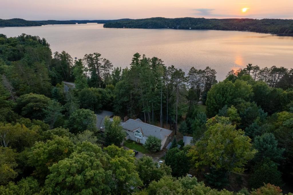 an aerial view of a house on the shore of a lake at Muskoka Waterfront Retreat in Dwight