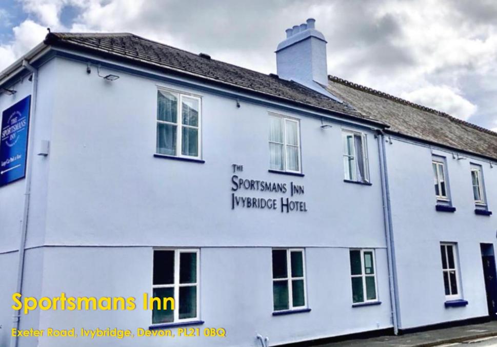 a white building with writing on the side of it at The Sportsmans Inn Limited in Ivybridge