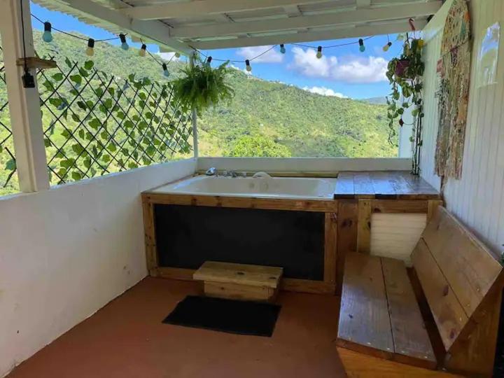 a kitchen with a sink and a large window at Casa Bali PR in Guayama