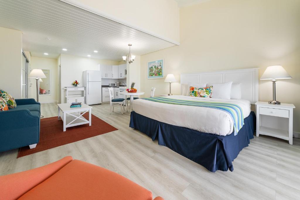 a bedroom with a large bed and a living room at La Vista Resort in Simpson Bay