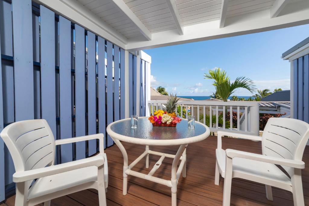 a patio with a table and chairs on a balcony at La Vista Resort in Simpson Bay