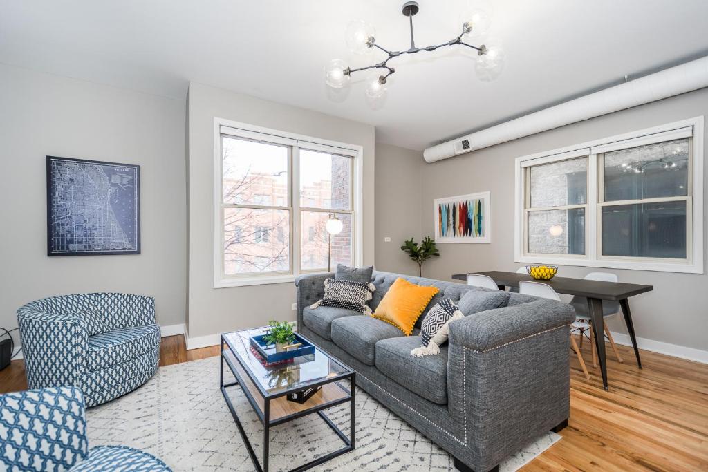 a living room with a couch and a table at Vibrant and Modern 2-Bedroom Home Near Downtown in Chicago