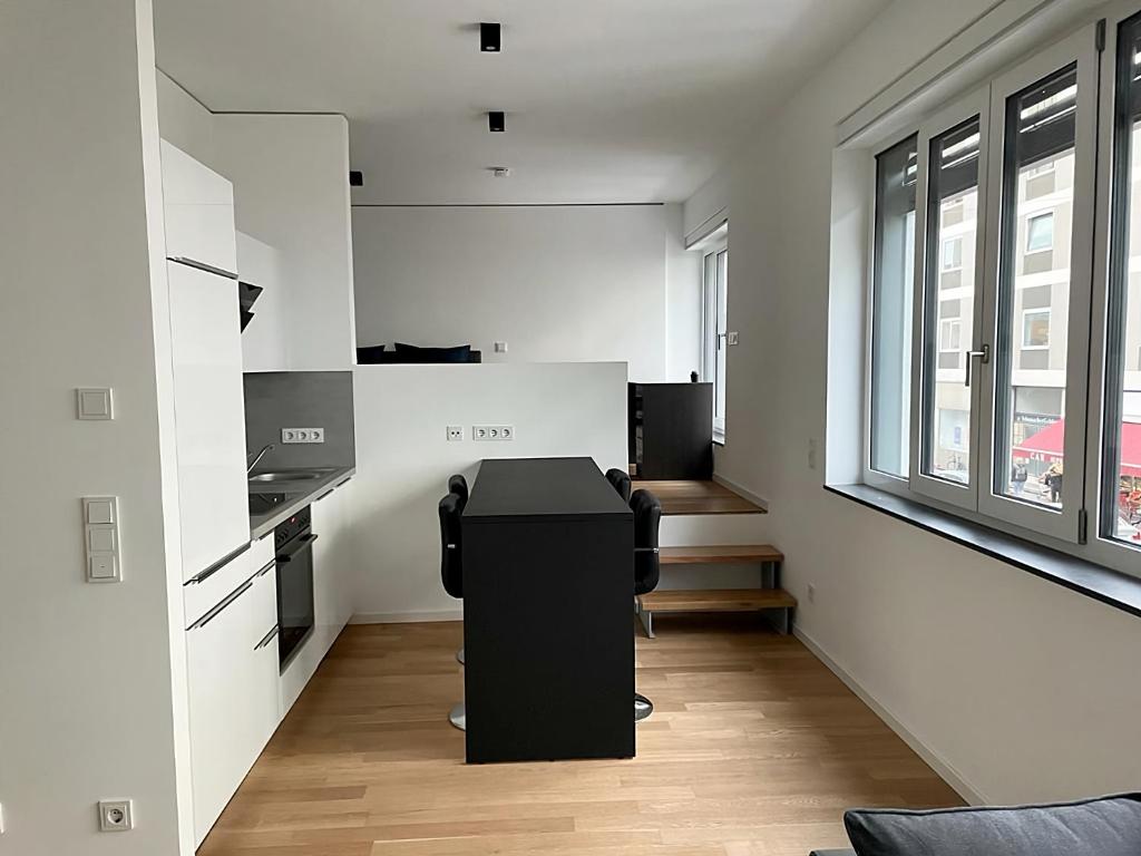 a room with a desk in the middle of a room at Modern Apartment in the center of Munich in Munich