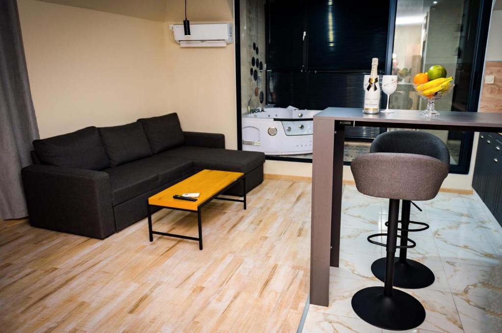 - un salon avec un canapé et une table dans l'établissement Panorama Suites, à Pleven