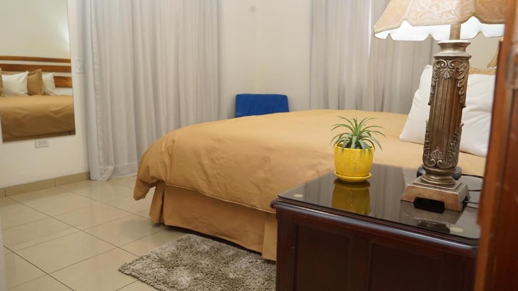 Postel nebo postele na pokoji v ubytování Hotel Casa del Arbol