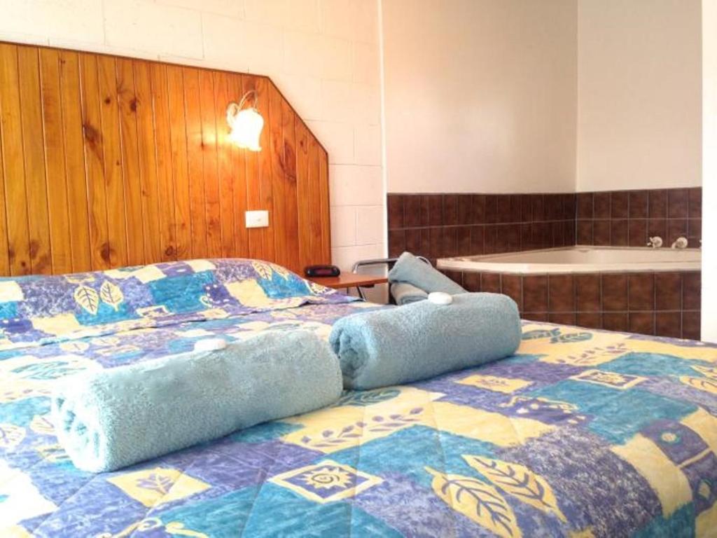 Postel nebo postele na pokoji v ubytování Pelicans Motel San Remo