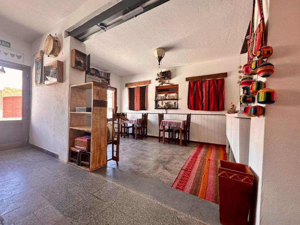 a living room with a kitchen and a dining room at La Colorada Hostal in Tilcara