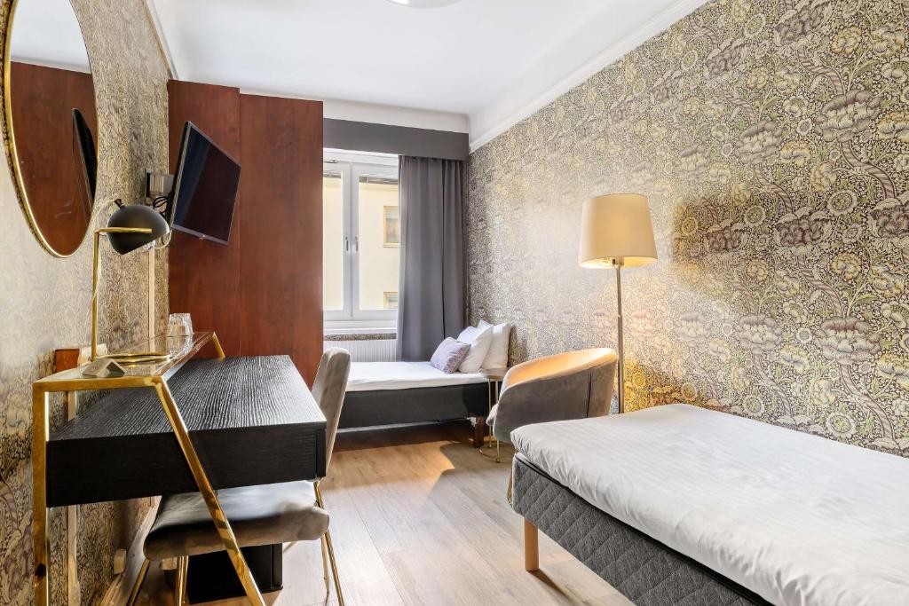 Postel nebo postele na pokoji v ubytování Centric Hotel