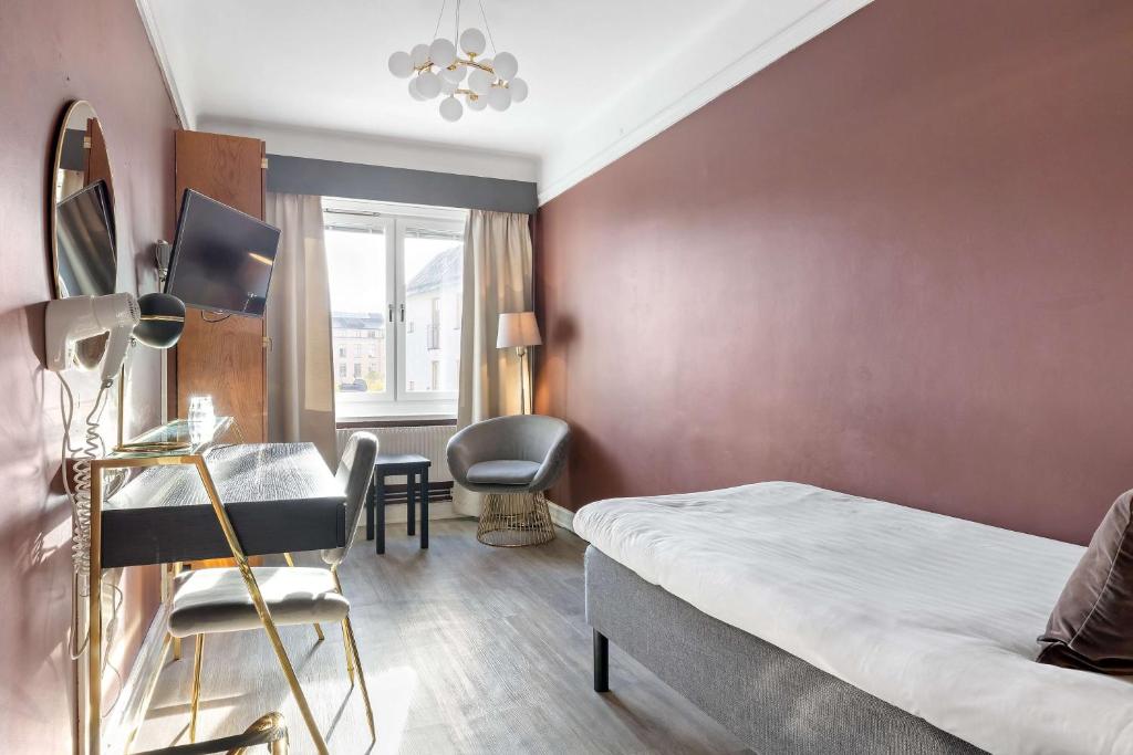 Postel nebo postele na pokoji v ubytování Centric Hotel