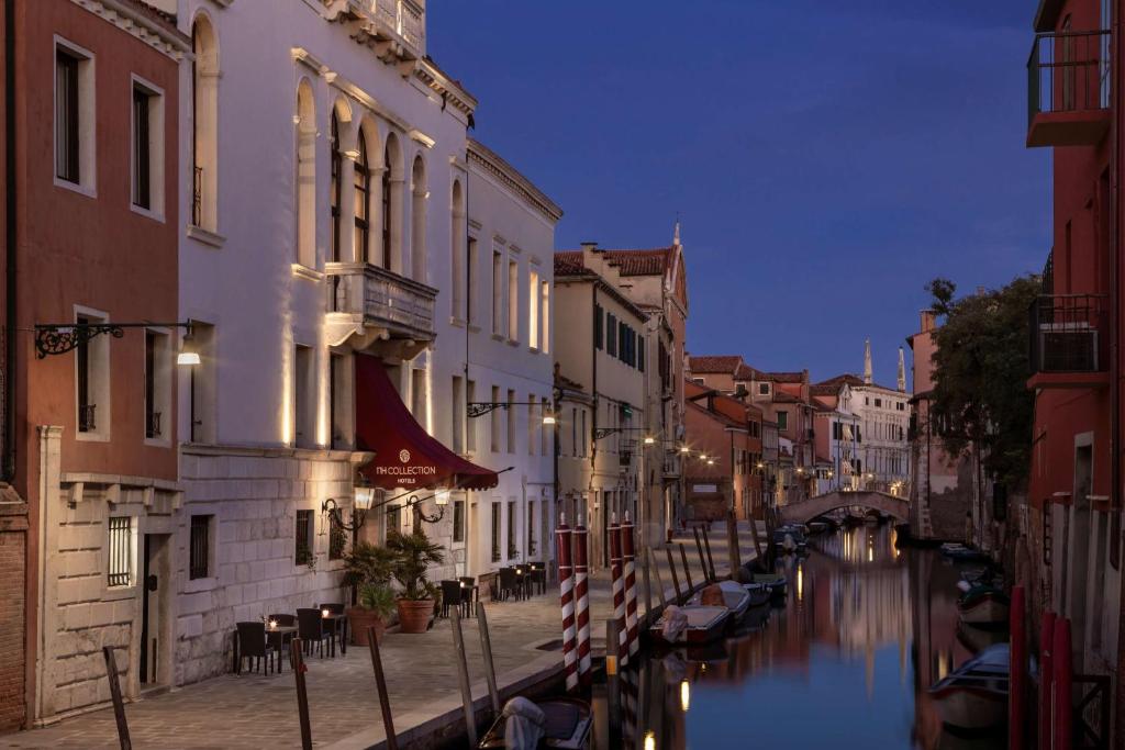 Blick auf einen Kanal in einer Stadt in der Nacht in der Unterkunft NH Collection Grand Hotel Palazzo Dei Dogi in Venedig