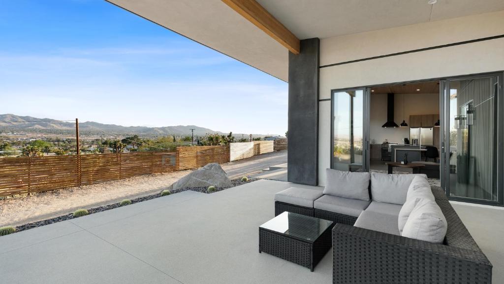 a living room with a couch and a view at Desert Ridge - Hot Tub, Fire Pit, BBQ, Out Door Shower & Incredi home in Yucca Valley