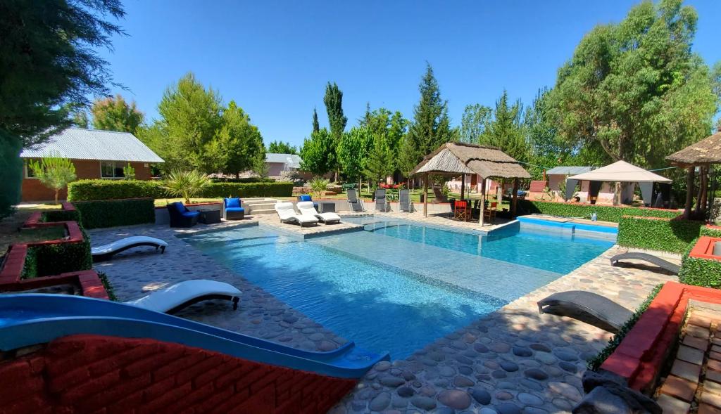 una grande piscina con sedie e un resort di Complejo Ermitazh a Valle Grande