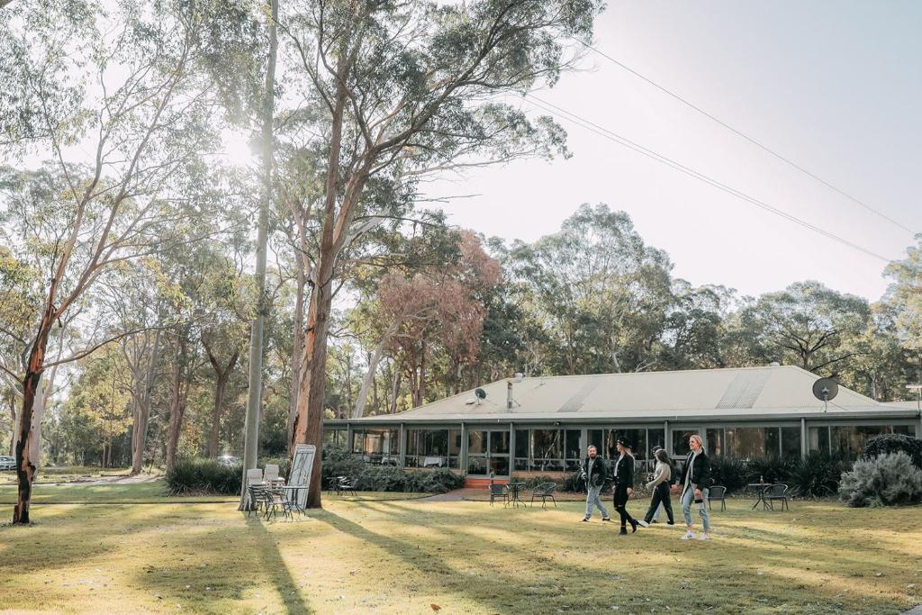 a group of people walking in front of a building at Hunter Valley Retreat in Quorrobolong